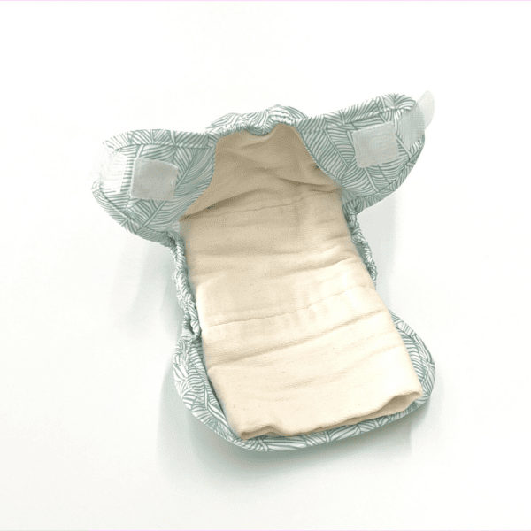 prefold diaper folded inside newborn cover