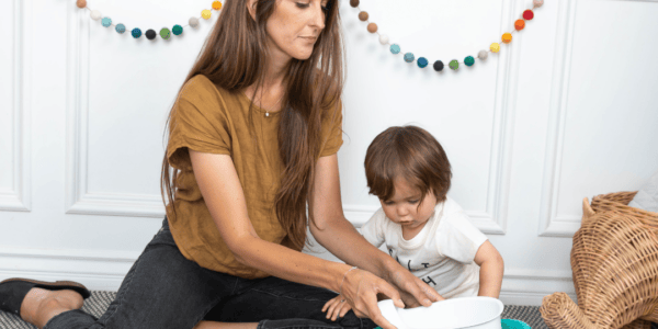 mother and toddler looking at a training toilet