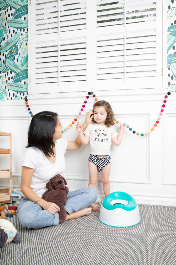 mother and toddler looking at training toilet